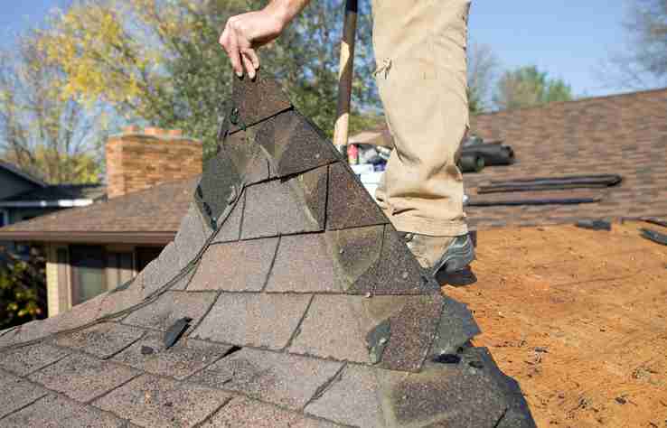 worker repairing a roof